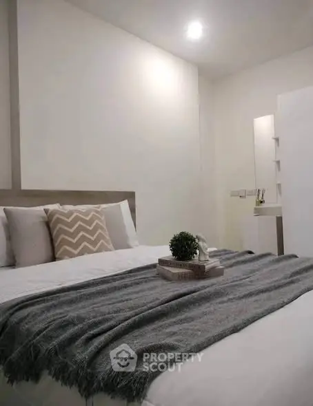 Cozy modern bedroom with stylish decor and soft lighting, perfect for relaxation.