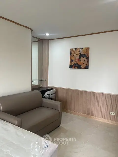 Cozy living room with modern sofa and elegant wall art in a stylish apartment.