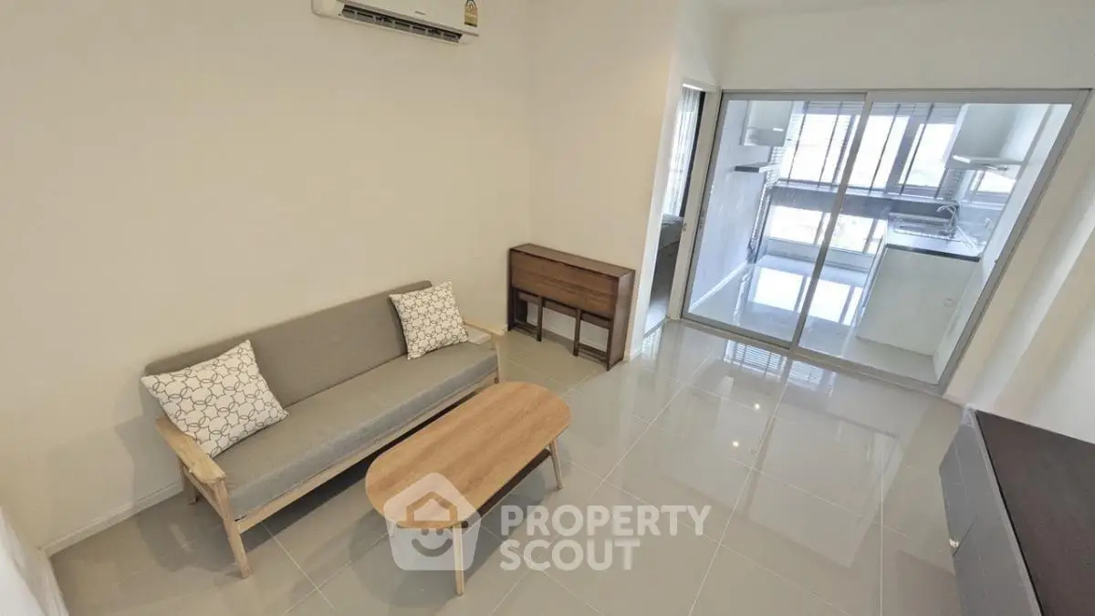 Modern living room with sleek furniture and glass sliding doors
