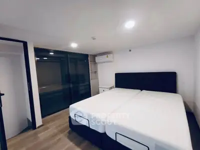 Spacious modern bedroom with large bed and sleek design, perfect for comfort and relaxation.