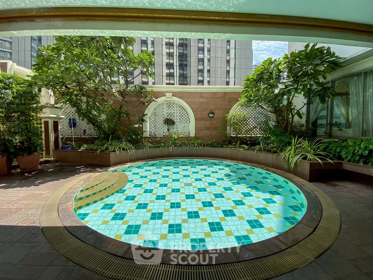 Luxurious rooftop pool with lush greenery and city views, perfect for relaxation and leisure.