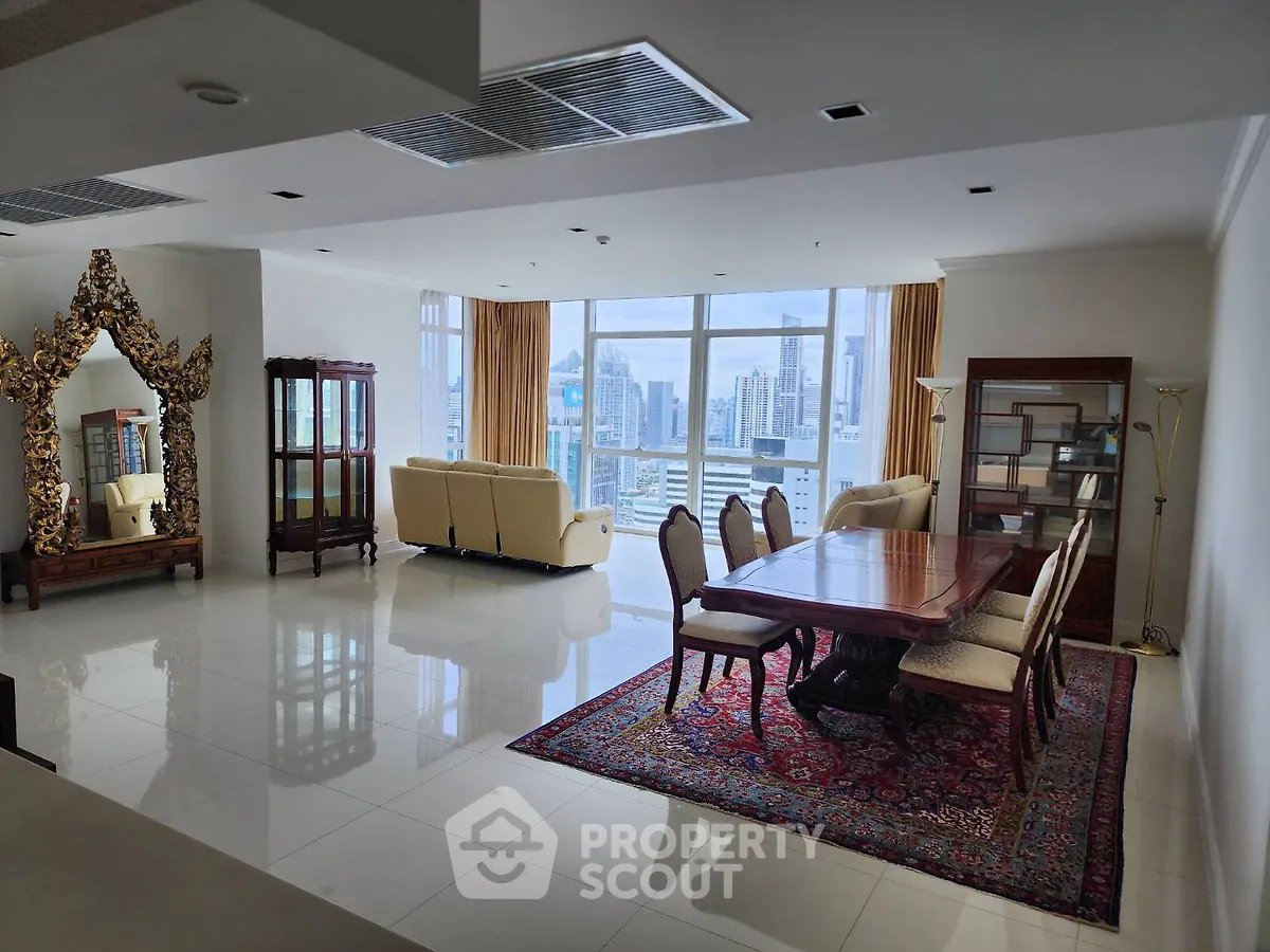 Spacious living room with elegant dining area and city view