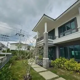 Modern two-story house with lush garden and spacious balcony