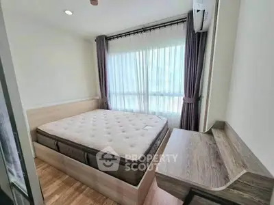 Modern bedroom with large window and stylish wooden furniture