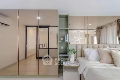 Luxurious modern bedroom with mirrored wardrobe and elegant decor