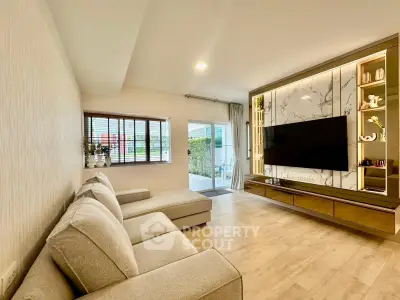 Spacious modern living room with elegant decor and large TV