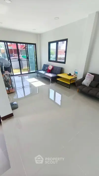 Spacious living room with modern furniture and large windows for natural light.