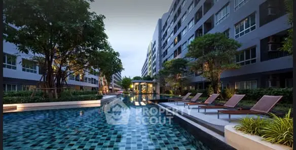 Luxurious apartment complex with stunning pool and lush greenery