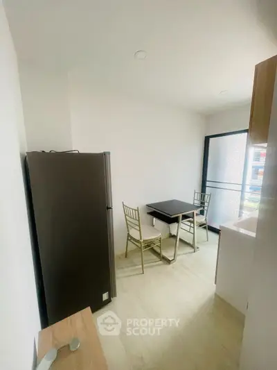 Cozy kitchen with dining area and modern appliances in a bright apartment.
