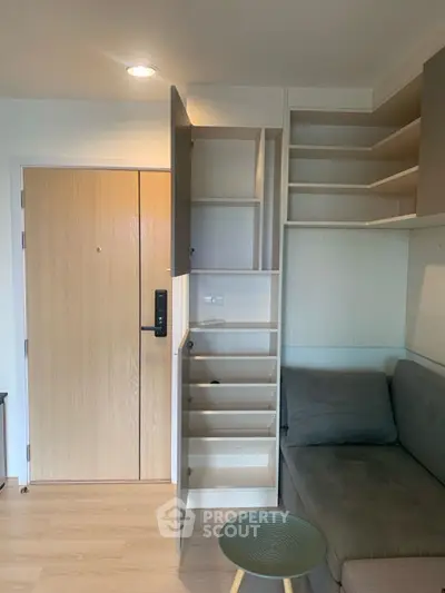 Modern apartment entrance with built-in storage and cozy seating area.