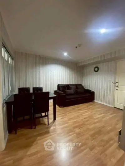 Cozy living room with wooden flooring and elegant furniture in a modern apartment.