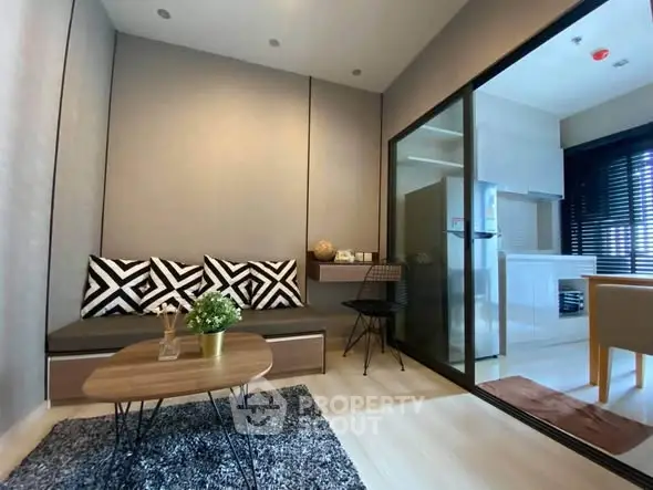 Modern living room with stylish decor and open kitchen layout in a contemporary apartment.