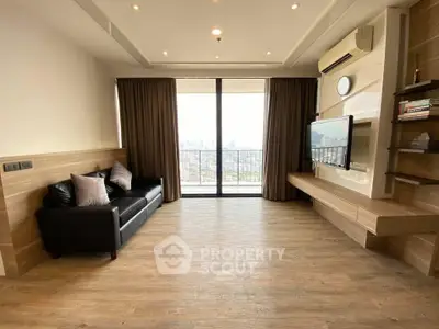 Spacious living room with city view, modern decor, and wooden flooring