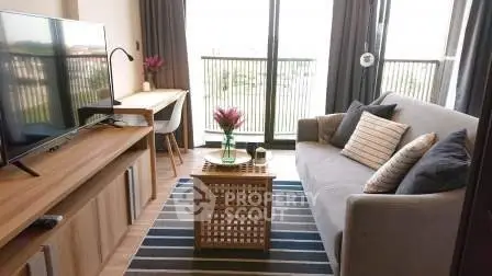 Modern living room with stylish decor and balcony view, featuring a cozy sofa and entertainment setup.