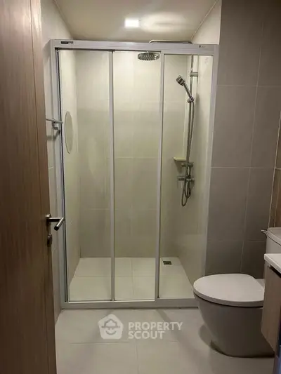 Modern bathroom with glass shower enclosure and sleek fixtures