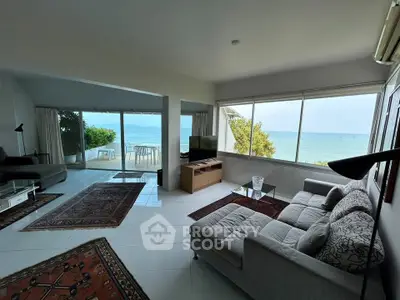 Stunning beachfront living room with panoramic sea views and modern decor
