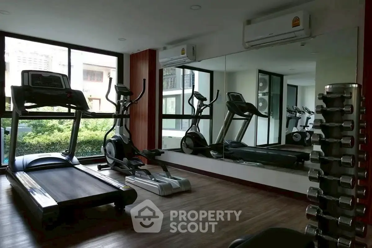 Modern gym with treadmill and elliptical in a bright fitness room
