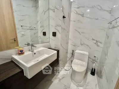 Modern bathroom with sleek marble tiles and contemporary fixtures