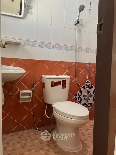 Charming bathroom with colorful tiles and modern fixtures, perfect for a cozy home.