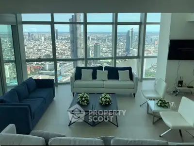 Luxurious high-rise living room with panoramic city views and modern furnishings.