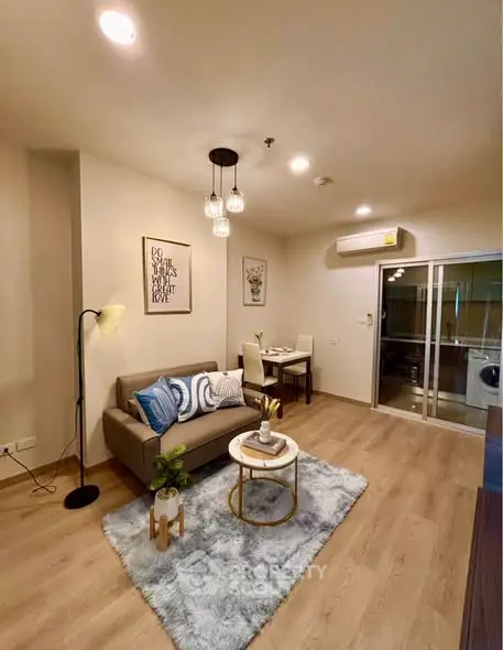 Stylish living room with modern decor and cozy ambiance, featuring elegant lighting and a plush rug.