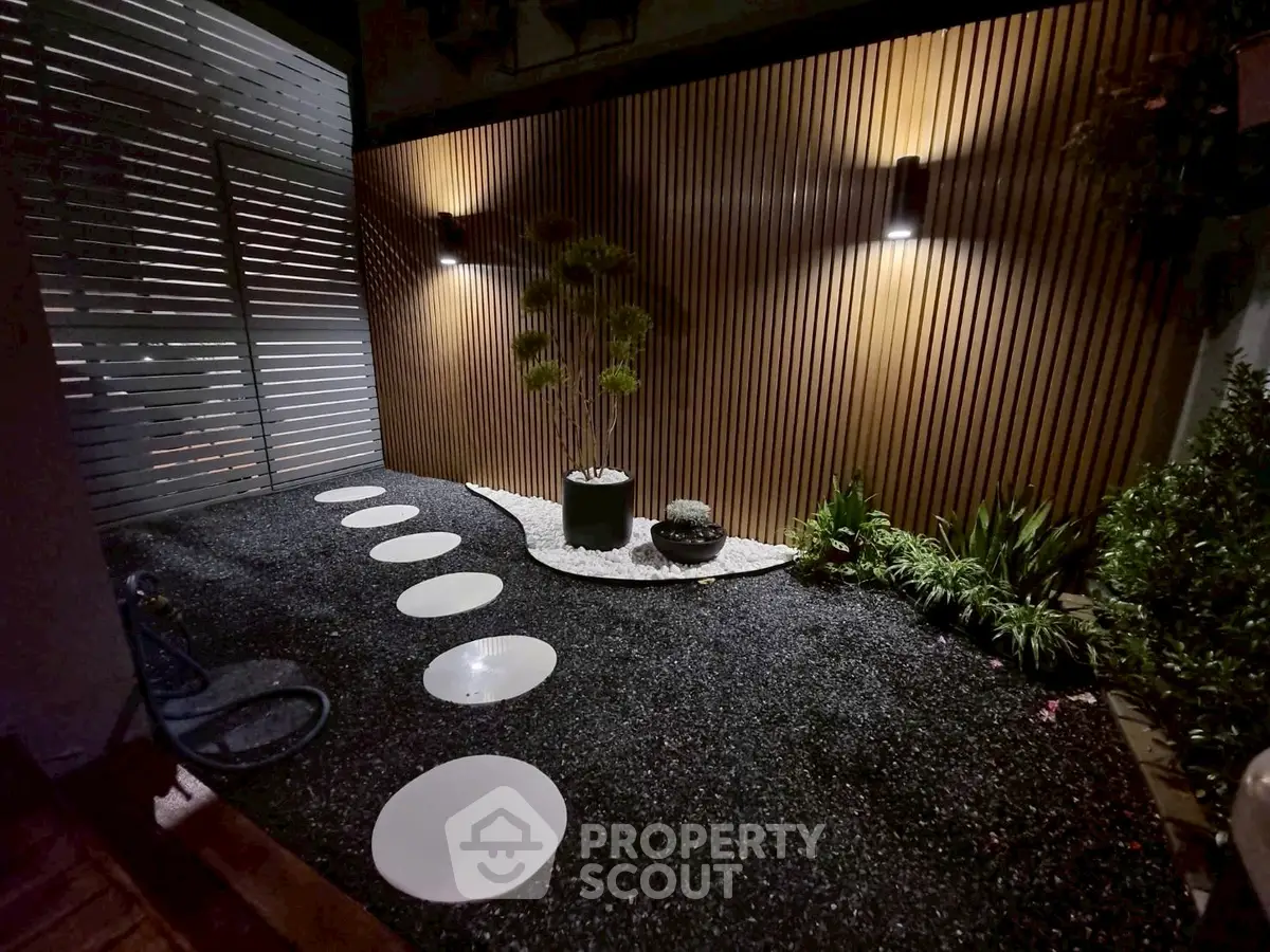 Modern garden with stylish lighting and stepping stones, perfect for serene outdoor relaxation.