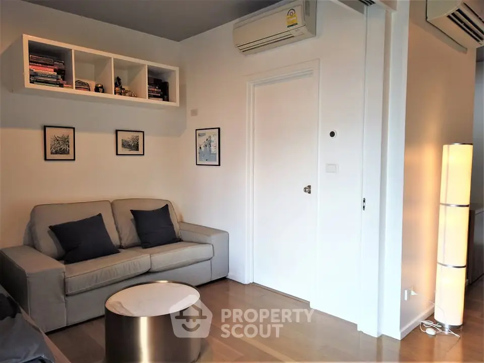 Modern living room with sleek furniture and wall-mounted air conditioning