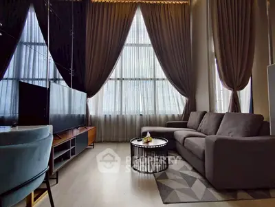Spacious living room with high ceilings and modern decor