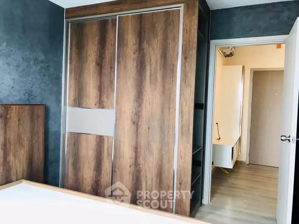 Modern bedroom with stylish wooden wardrobe and sleek flooring