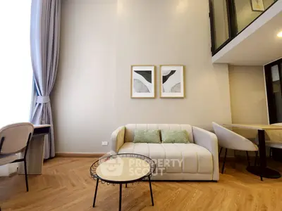 Modern living room with stylish furniture and elegant decor in a bright, open space.