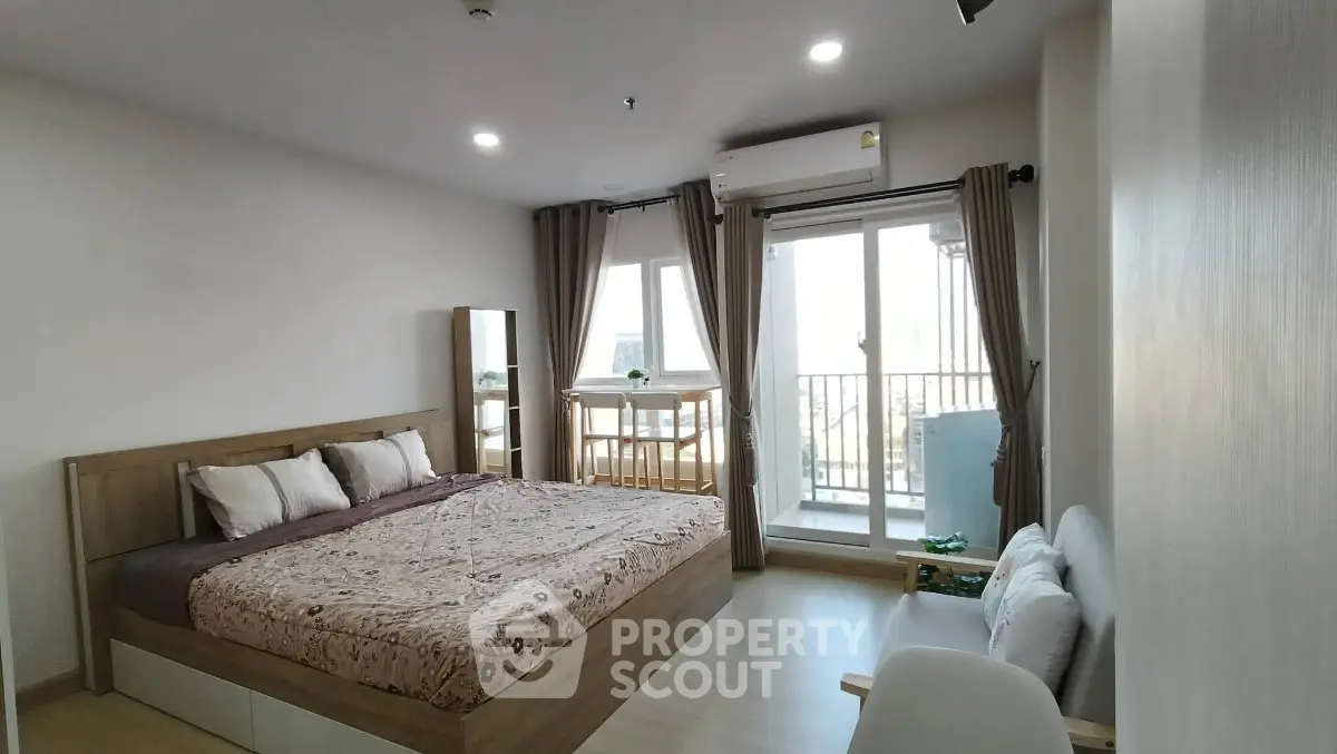 Spacious bedroom with balcony access in modern apartment