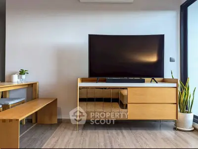 Modern living room with sleek wooden furniture and large flat-screen TV, perfect for contemporary urban living.