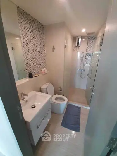 Modern bathroom with sleek fixtures and stylish tile accents in a contemporary apartment.