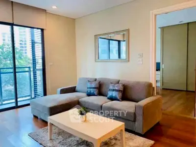 Modern living room with cozy sofa and balcony view in stylish apartment.