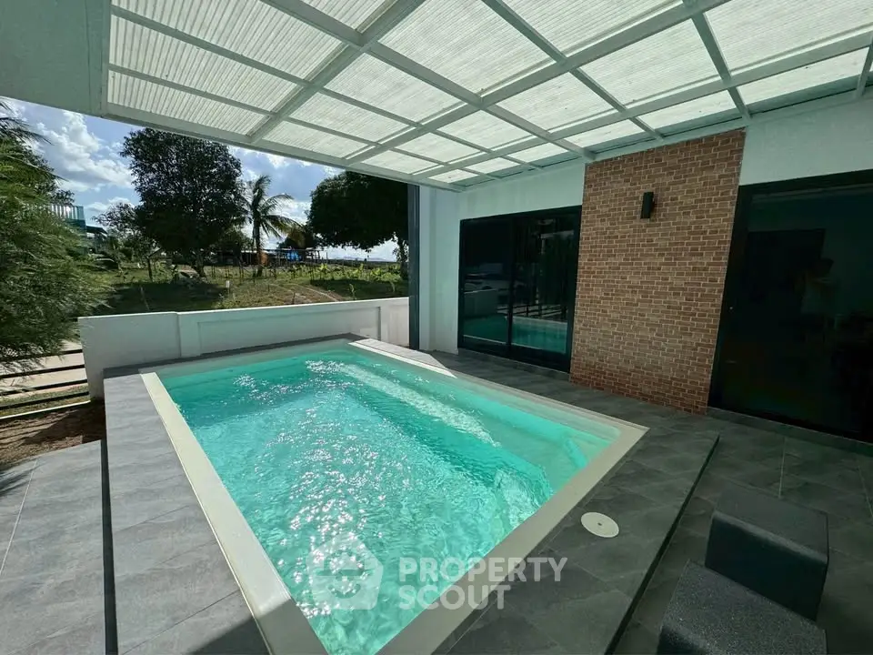Luxurious private pool area with modern design and lush greenery, perfect for relaxation and entertainment.