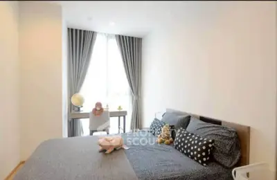 Cozy bedroom with stylish decor and ample natural light, perfect for relaxation and comfort.