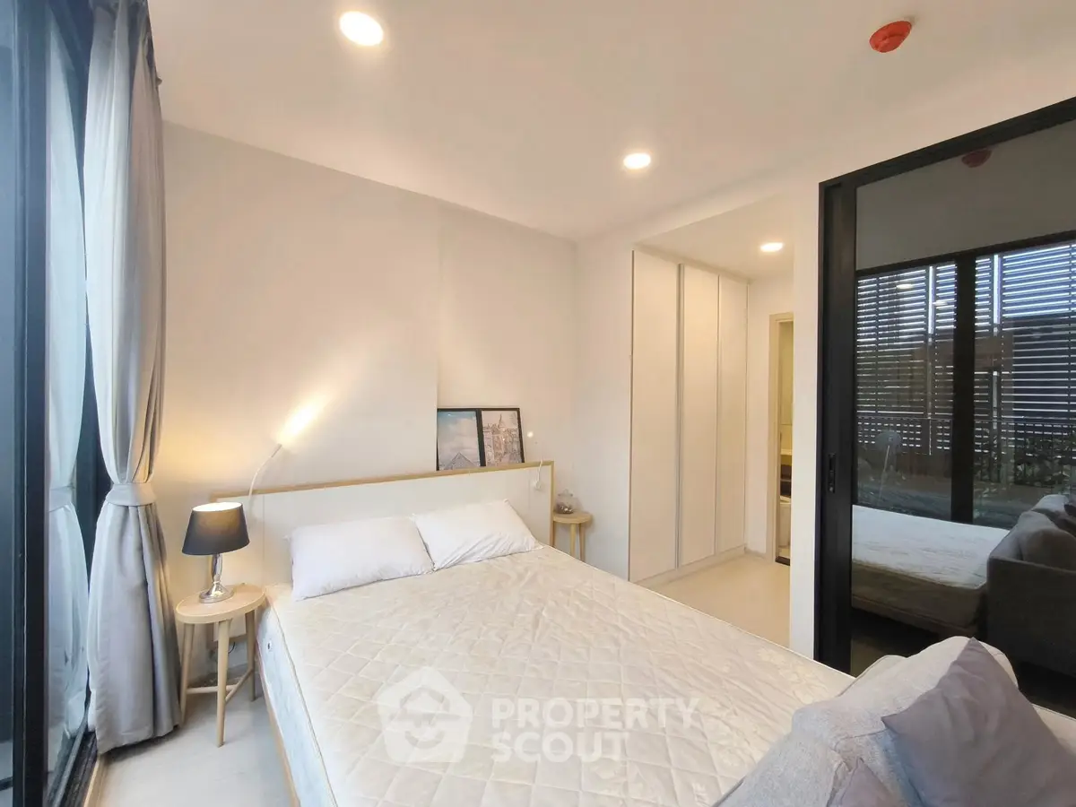 Modern bedroom with cozy lighting and large window view