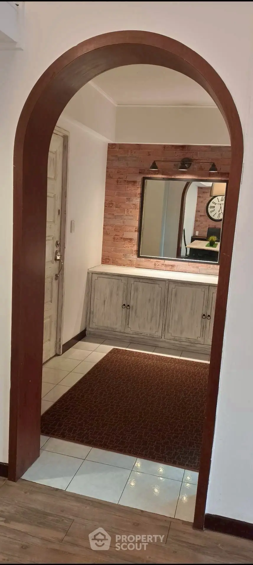 Charming interior with rustic archway and stylish brick accent wall