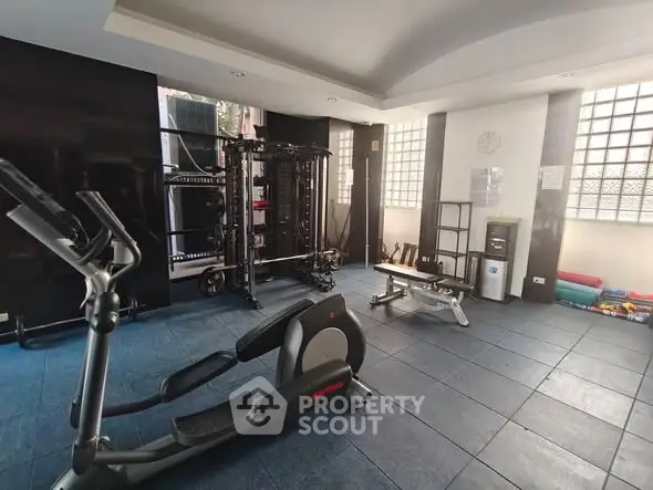 Modern gym with exercise equipment and natural light