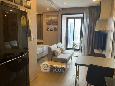 Modern studio apartment with open layout, featuring a cozy living area and balcony with city view.