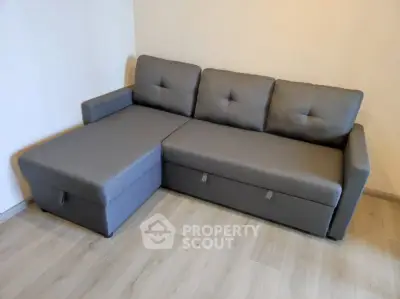 Modern gray sectional sofa in a minimalist living room setting