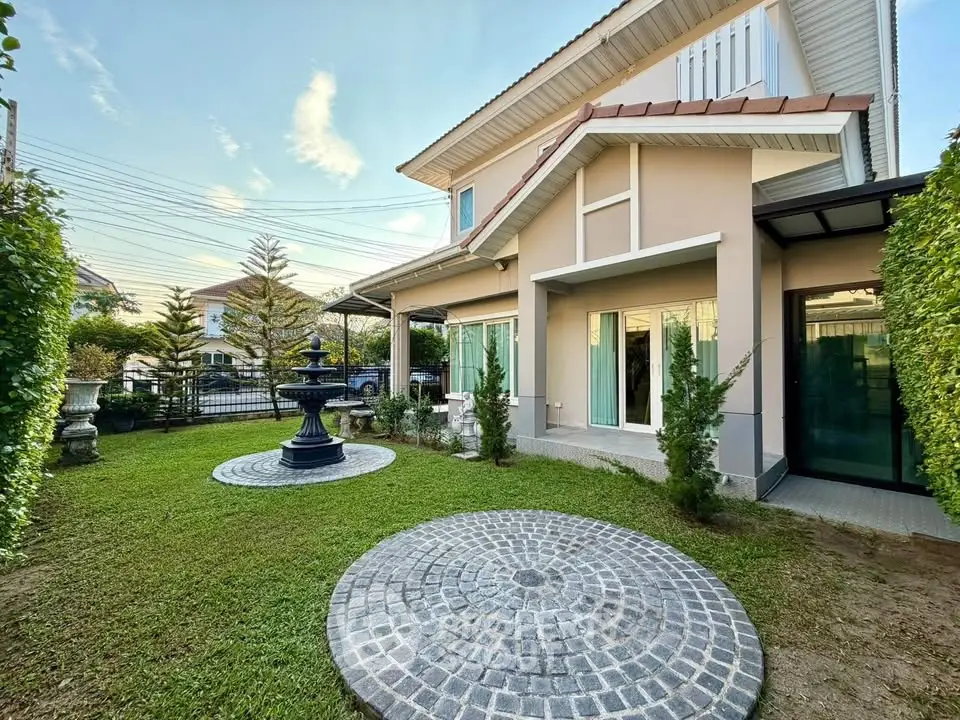 Charming two-story house with lush garden and elegant fountain in a serene neighborhood.