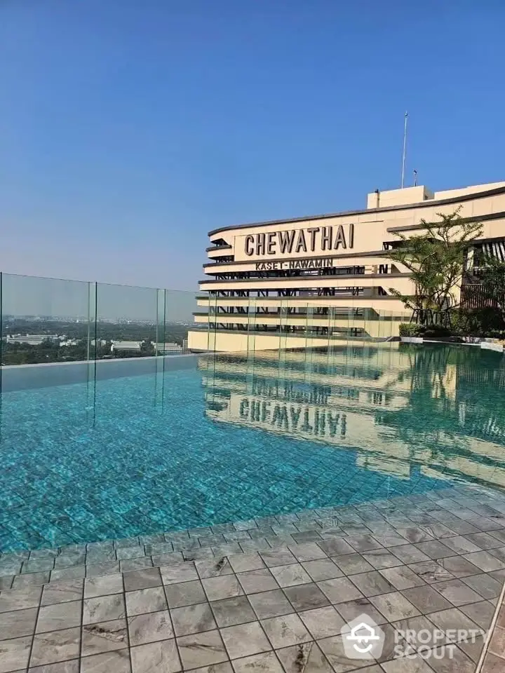 Luxurious rooftop infinity pool with stunning city views and modern glass railing.