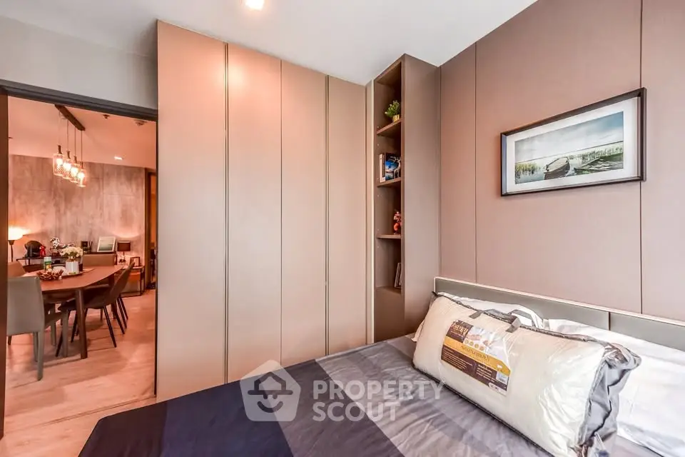 Modern bedroom with sleek design and view into stylish dining area