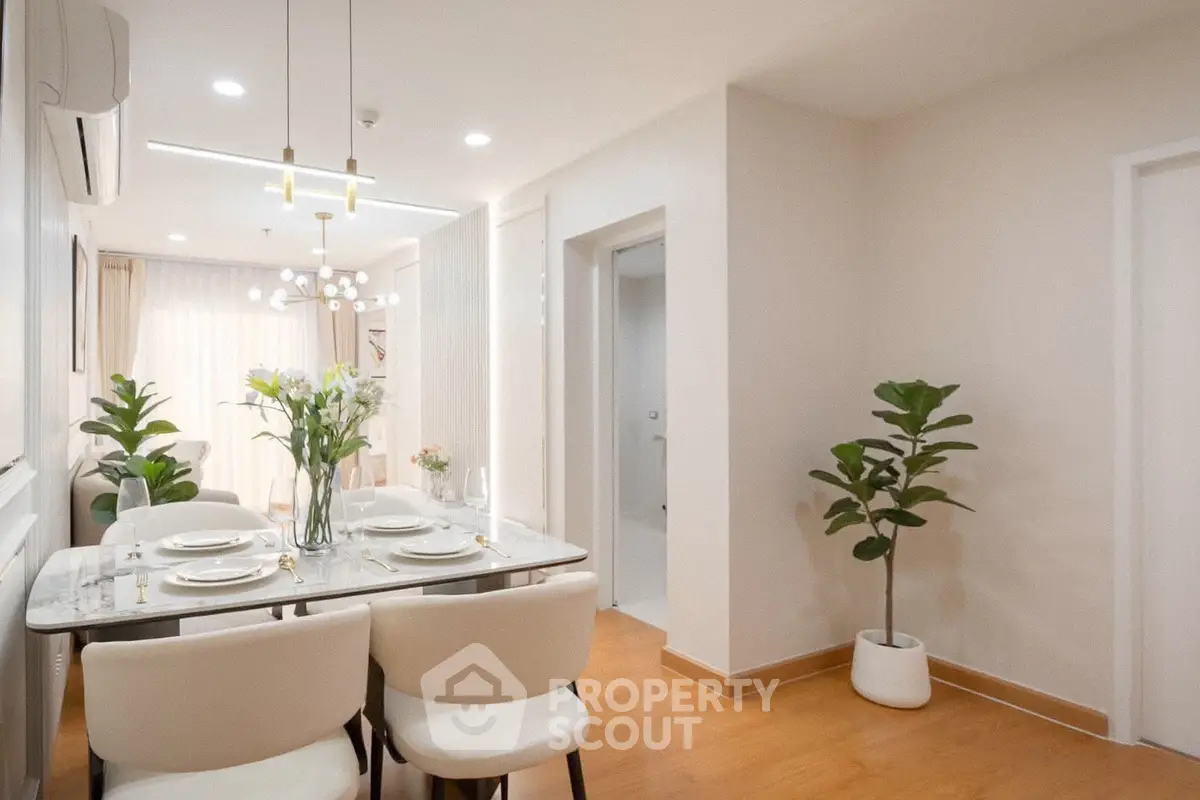 Elegant dining area with modern decor and natural light in a stylish apartment.