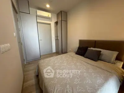 Cozy bedroom with modern decor and ample storage space in a stylish apartment.