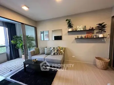 Modern living room with stylish decor and balcony view, featuring cozy seating and elegant shelving.