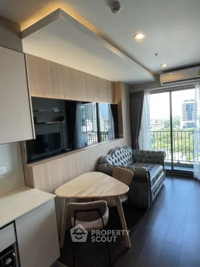 Modern living room with city view, stylish furniture, and natural light.