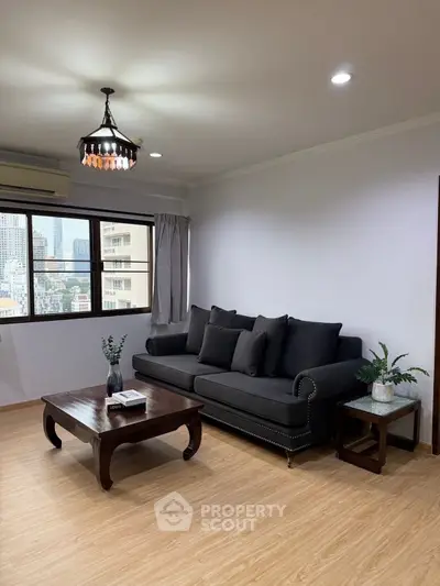 Stylish living room with elegant sofa and city view window, perfect for modern urban living.