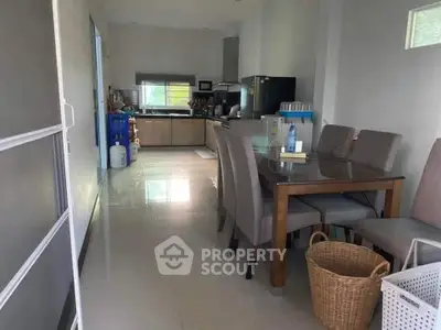 Spacious kitchen and dining area with modern appliances and elegant dining set.